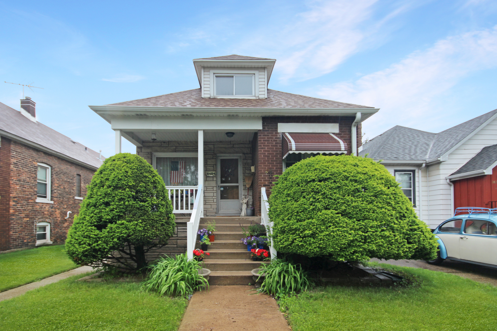 2424 Birch Avenue Whiting, IN 46394 - Photo 1 of 48 a front view of a house with a garden