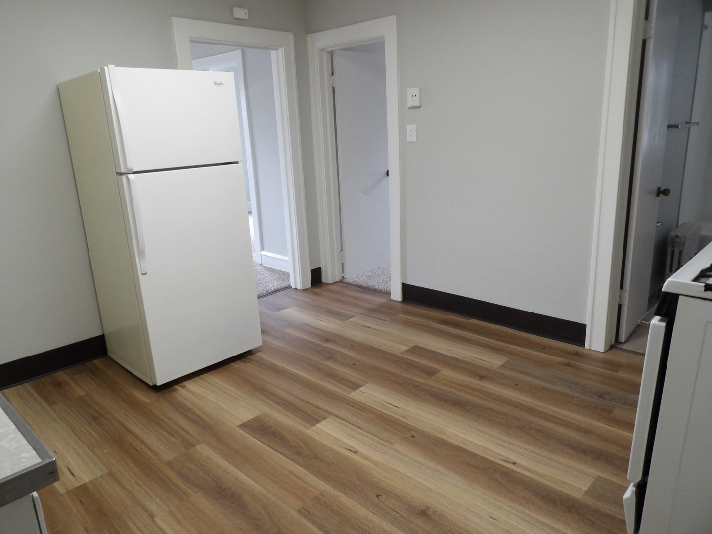 2424 Birch Avenue Whiting, IN 46394 - Photo 7 of 48 a view of a room with wooden floor and a refrigerator