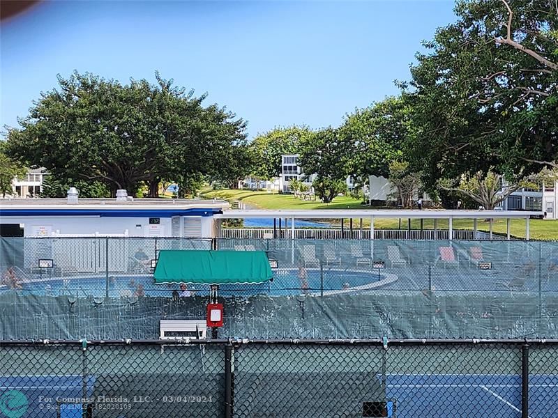 a view of a tennis court with a small yard