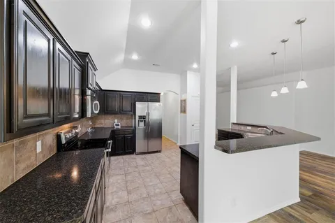a kitchen with stainless steel appliances a refrigerator and a sink
