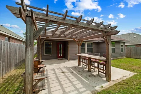 a view of a house with pool and chairs