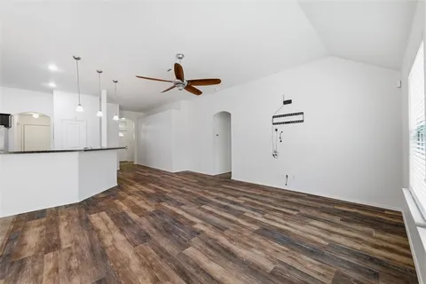 a view of a livingroom with a hardwood floor and a ceiling fan