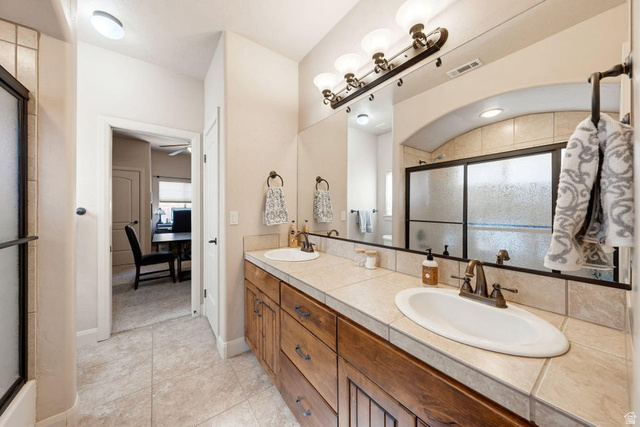 1609 East 10 S Street St. George, UT 84790 - Photo 38 of 68 Double vanity with wood-finish cabinetry and tile countertops