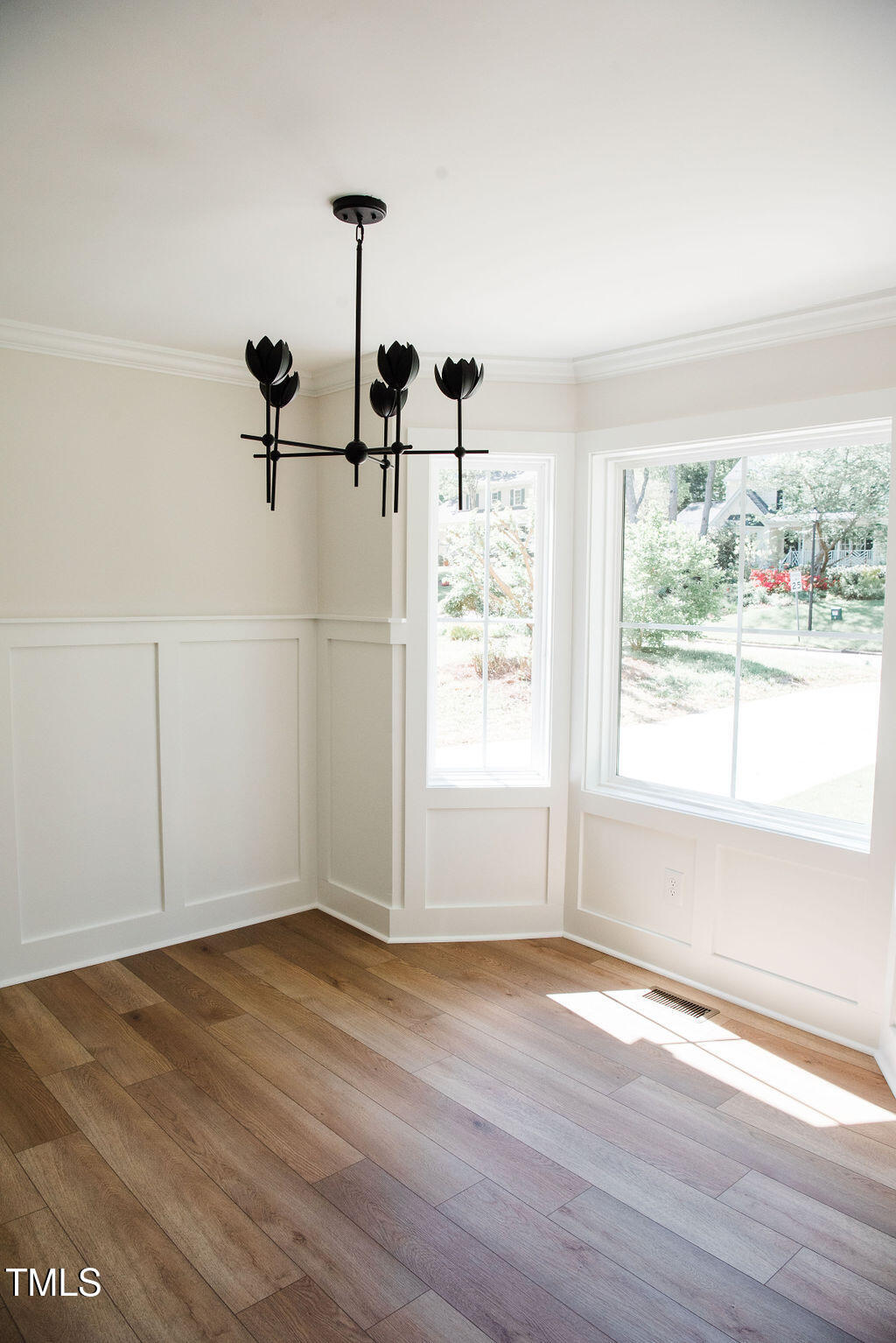 1326 Apache Lane Apex, NC 27502 - Photo 13 of 36 an empty room with wooden floor and windows