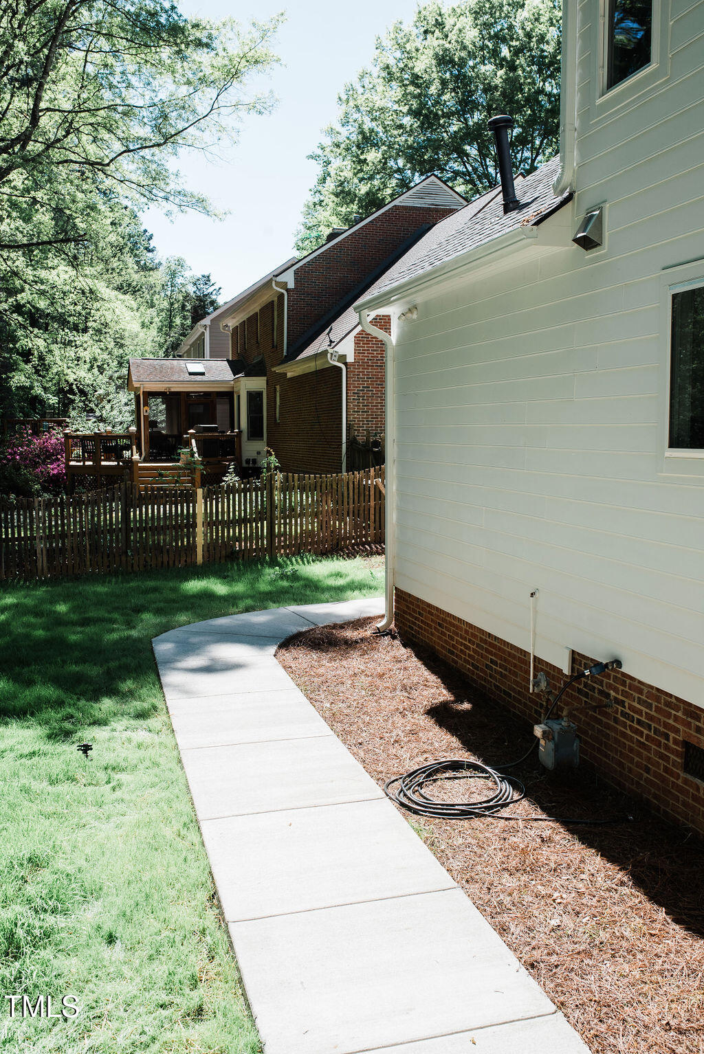1326 Apache Lane Apex, NC 27502 - Photo 24 of 36 a backyard of a house with lots of green space