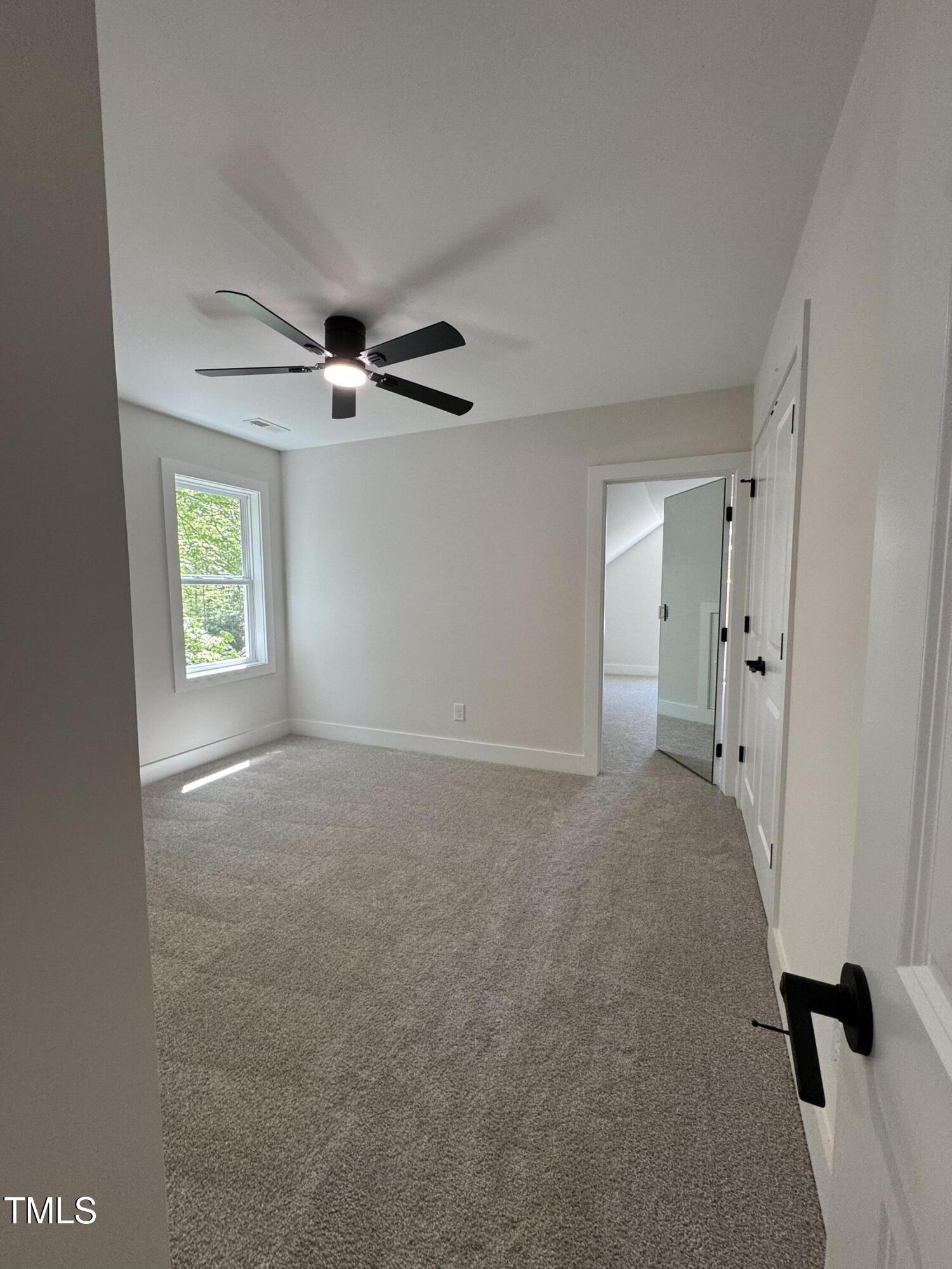 1326 Apache Lane Apex, NC 27502 - Photo 27 of 36 a view of a livingroom with a ceiling fan & windows