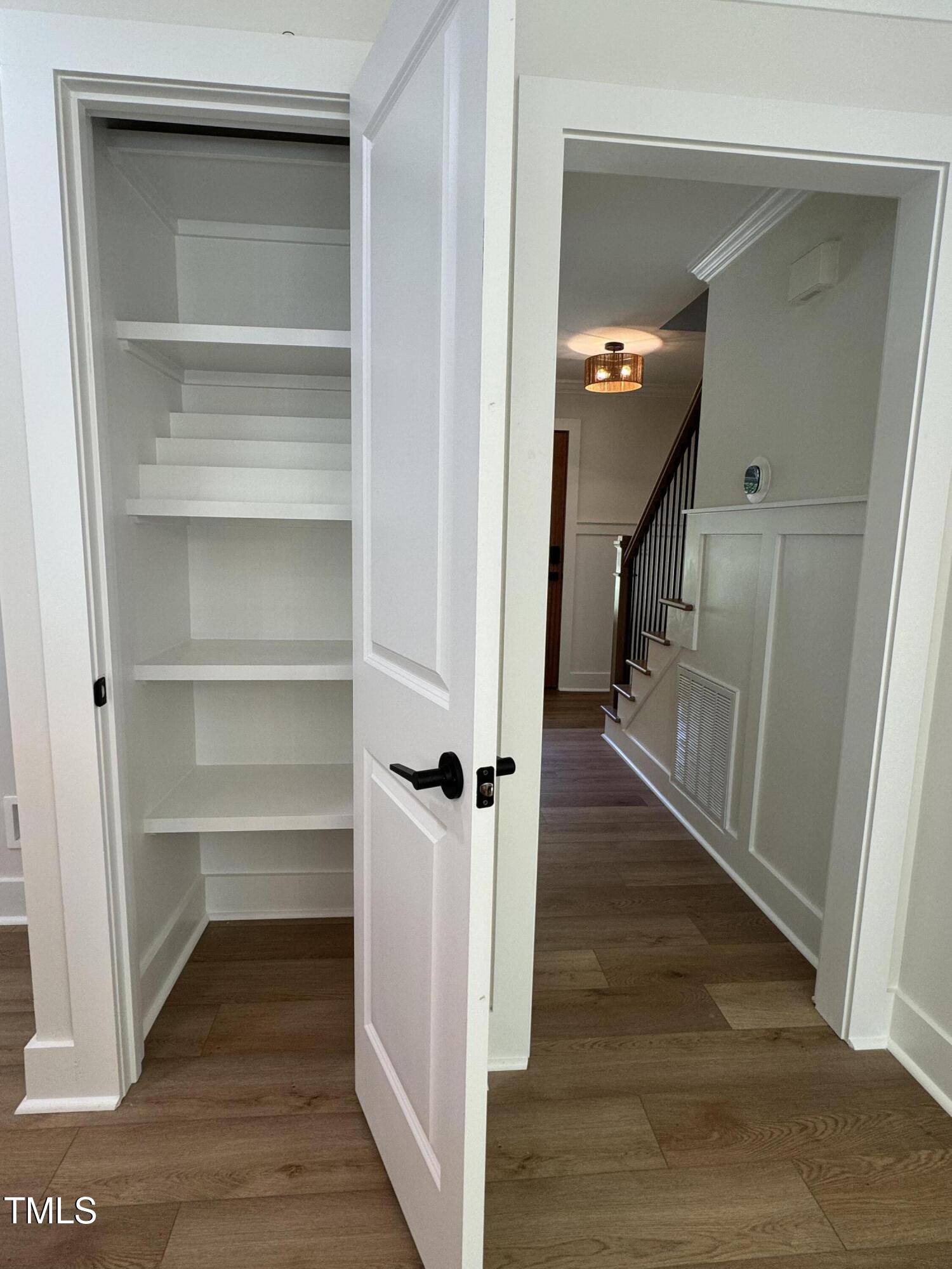 1326 Apache Lane Apex, NC 27502 - Photo 32 of 36 a view of a hallway view with wooden floor and staircase