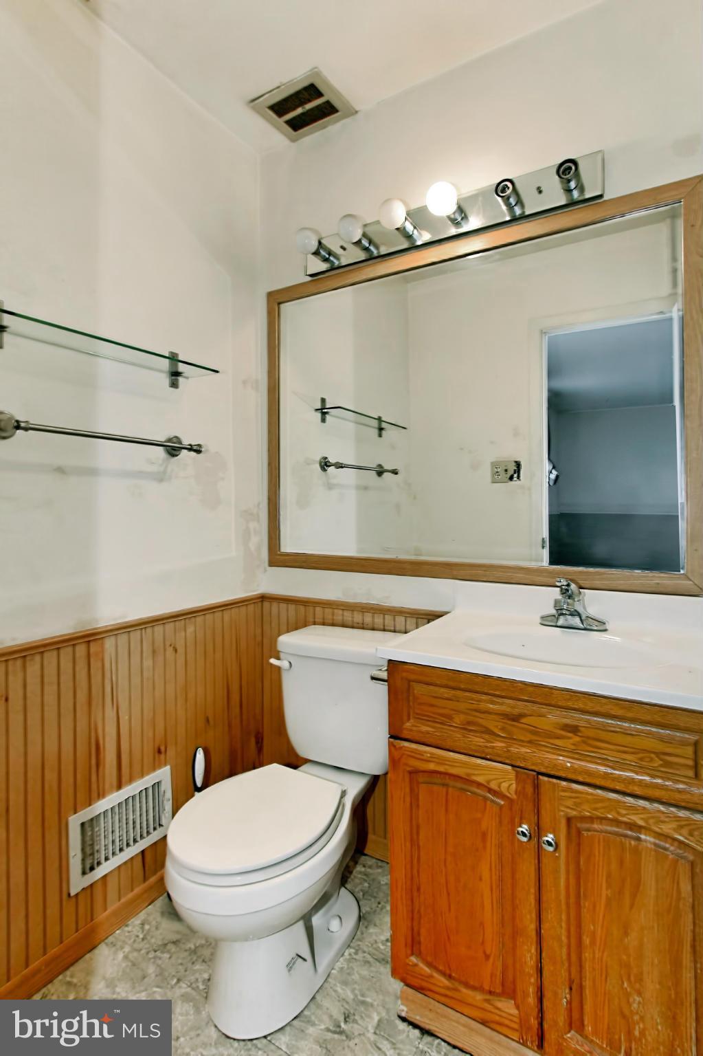 8126 Imperial Drive, Unit 5H Laurel, MD 20708 - Photo 16 of 30 a bathroom with a granite countertop toilet sink and mirror