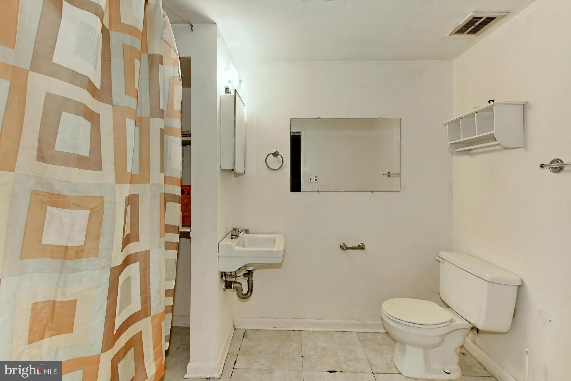 8126 Imperial Drive, Unit 5H Laurel, MD 20708 - Photo 24 of 30 a bathroom with a toilet sink and shower