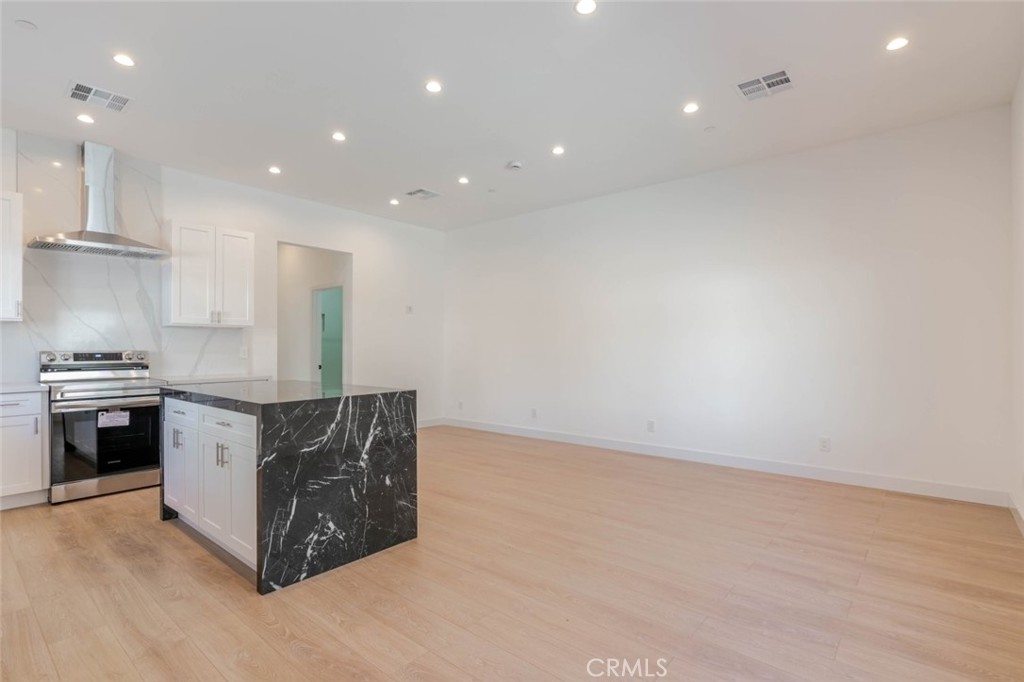 6852 1/2 Ranchito Avenue Van Nuys, CA 91405 - Photo 3 of 17 a kitchen with stainless steel appliances granite countertop a stove and a refrigerator