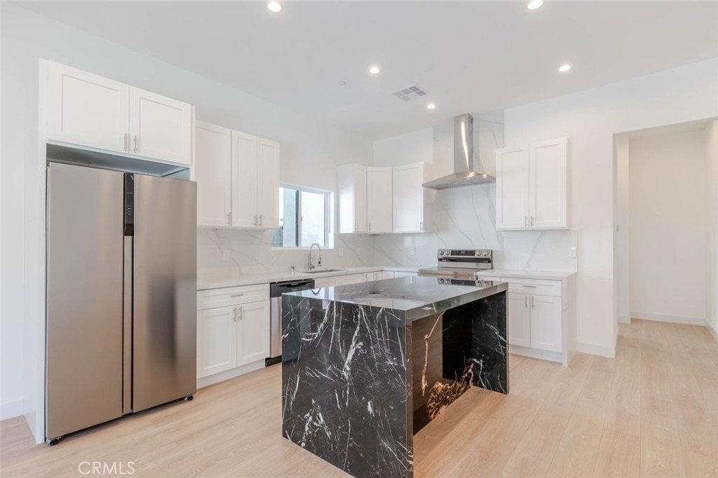 6852 1/2 Ranchito Avenue Van Nuys, CA 91405 - Photo 6 of 17 a kitchen with a stove a refrigerator and a sink