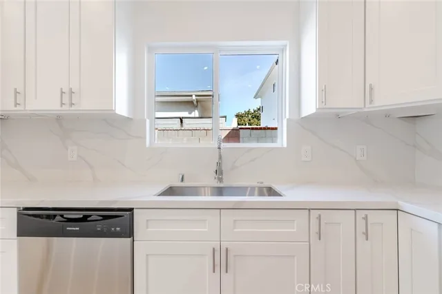 a kitchen with a sink and cabinets