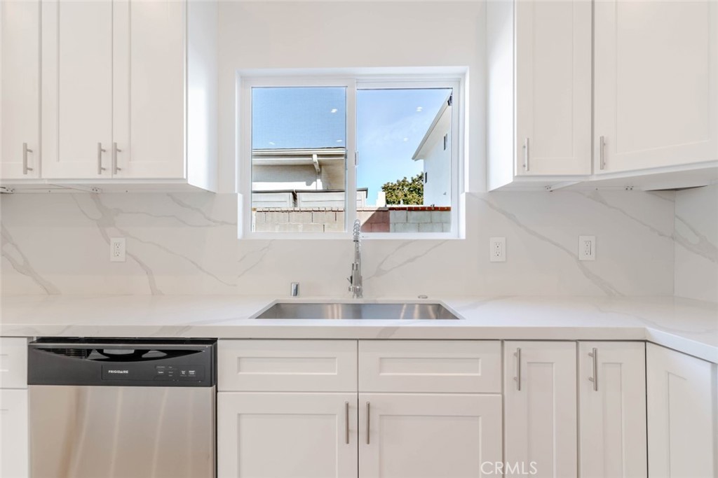 6852 1/2 Ranchito Avenue Van Nuys, CA 91405 - Photo 8 of 17 a kitchen with a sink and cabinets