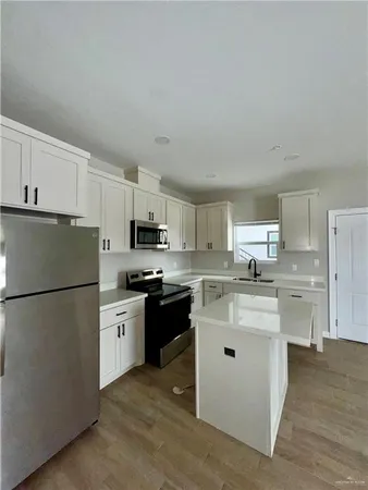 a kitchen with white cabinets and white appliances