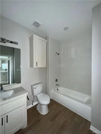 a bathroom with a toilet a sink and bathtub