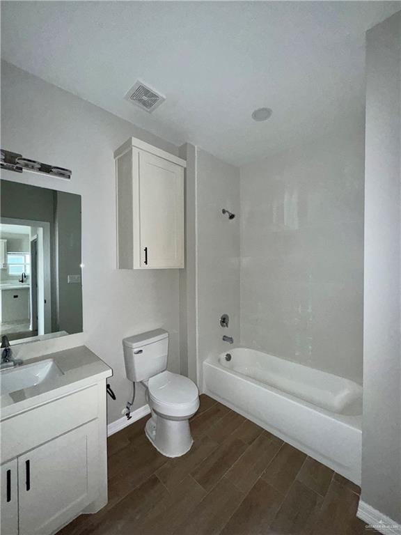 720 Ragland Road, Unit 3 Mission, TX 78572 - Photo 6 of 7 a bathroom with a toilet a sink and bathtub