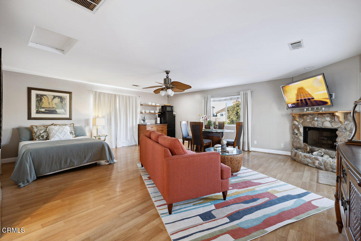 3701 Sunset Lane Oxnard, CA 93035 - Photo 20 of 54 a living room with furniture a fireplace and a flat screen tv