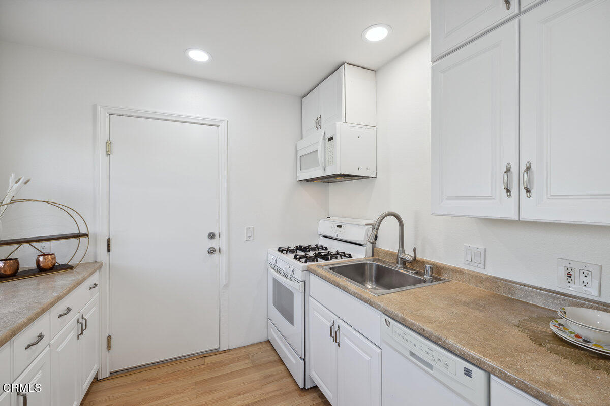 3701 Sunset Lane Oxnard, CA 93035 - Photo 41 of 54 a kitchen with granite countertop a sink a stove and cabinets
