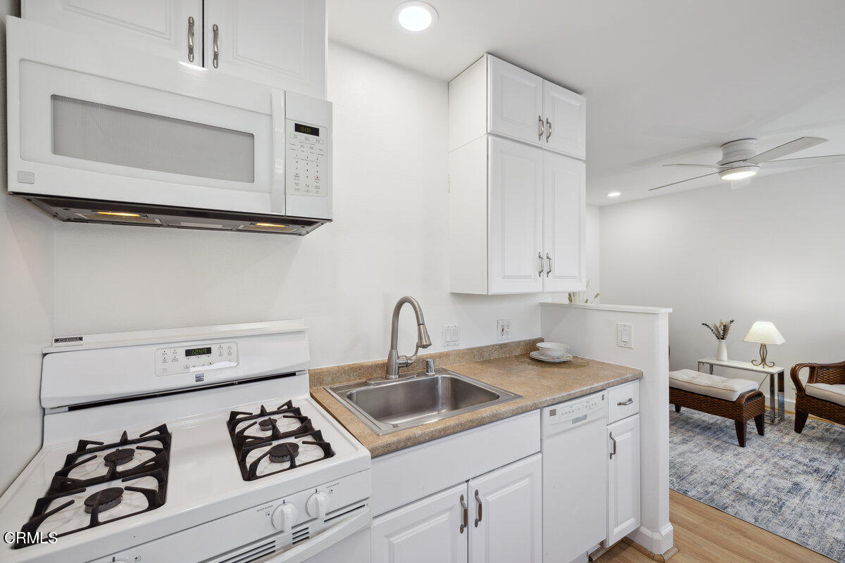 3701 Sunset Lane Oxnard, CA 93035 - Photo 43 of 54 a kitchen with white cabinets and white appliances