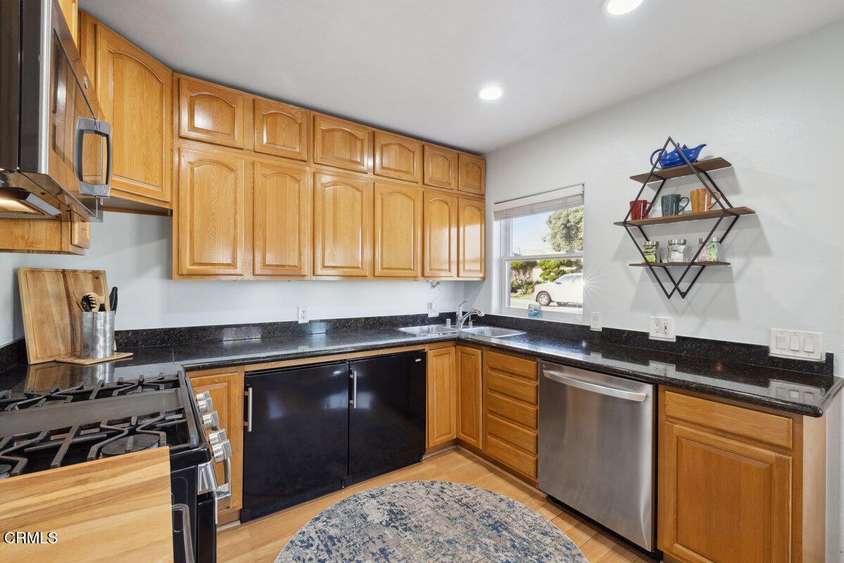3701 Sunset Lane Oxnard, CA 93035 - Photo 10 of 54 a kitchen with granite countertop a sink and a stove
