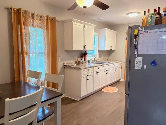 a kitchen with stainless steel appliances granite countertop a stove microwave and refrigerator