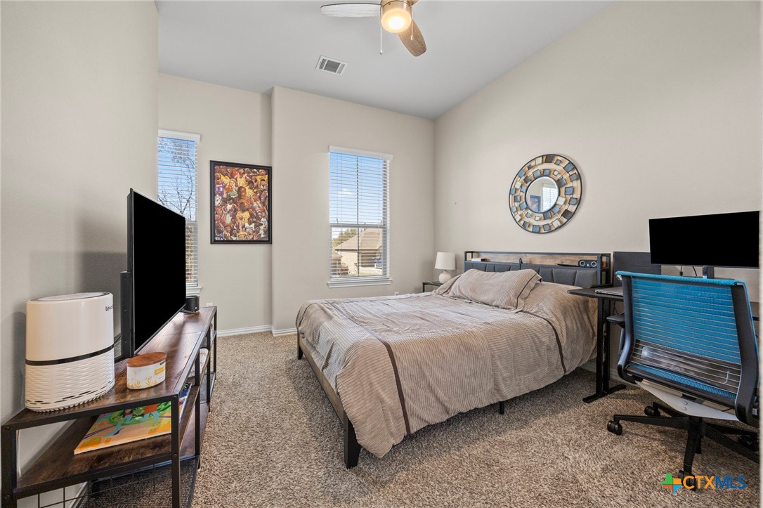 1205 Winding Way Drive Georgetown, TX 78628 - Photo 16 of 39 The third bedroom has a ceiling fan, carpet, and large window for natural light.