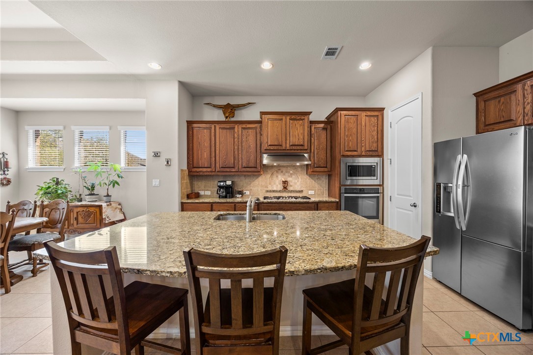 1205 Winding Way Drive Georgetown, TX 78628 - Photo 23 of 39 The kitchen has a large island that provides plenty of counter space and cabinets for storage.