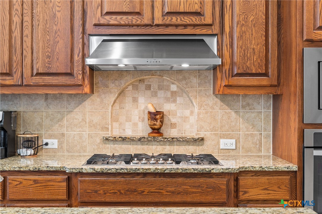 1205 Winding Way Drive Georgetown, TX 78628 - Photo 26 of 39 Built in Gas cooktop with vent hood.