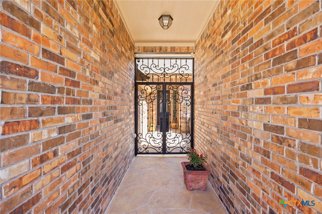 1205 Winding Way Drive Georgetown, TX 78628 - Photo 3 of 39 The outside entryway leads you to a custom metal gate that opens up into a private courtyard.