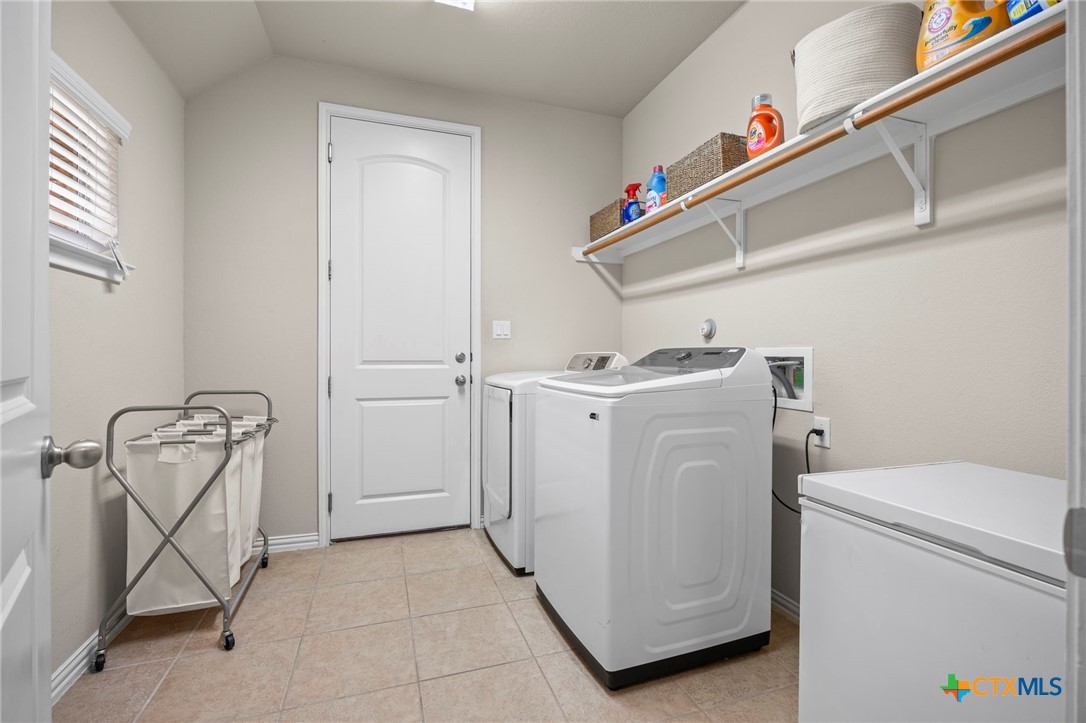 1205 Winding Way Drive Georgetown, TX 78628 - Photo 9 of 39 The laundry/ utility room is spacious and has a built in shelf, washer/dryer and deep freezer.
