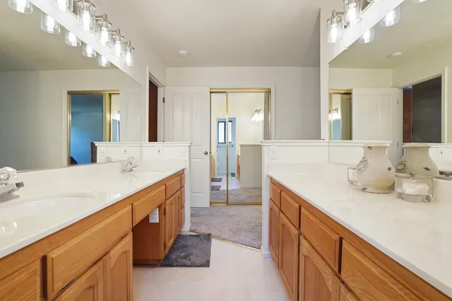 a spacious bathroom with a double vanity sink and a mirror