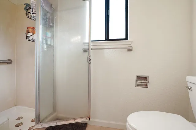 a white toilet sitting next to a bathroom sink