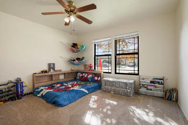a bedroom with bed and a window