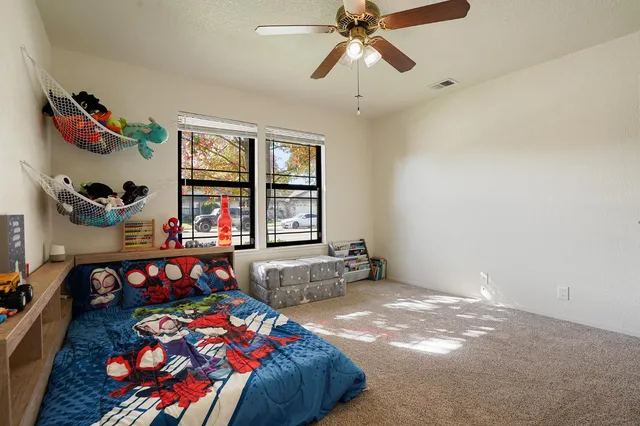 a bedroom with a bed and a chandelier