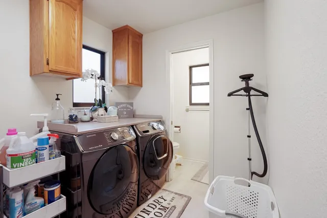 a bathroom with a granite countertop toilet sink and mirror