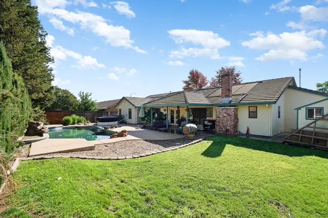 a front view of a house with garden and patio