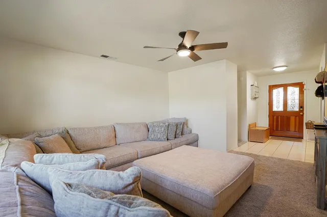a living room with furniture and a chandelier