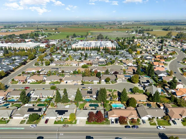 a white house with a yard and plants