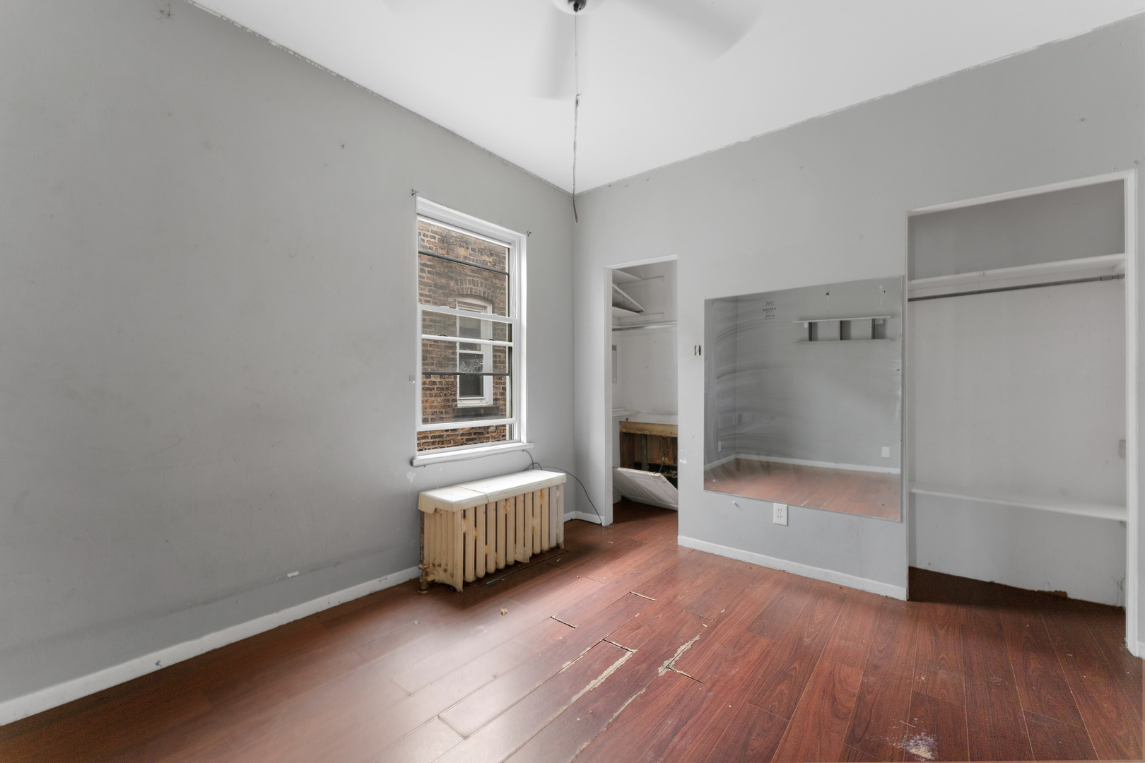 1657 North Austin Avenue Chicago, IL 60639 - Photo 12 of 36 a room with a bed and a window