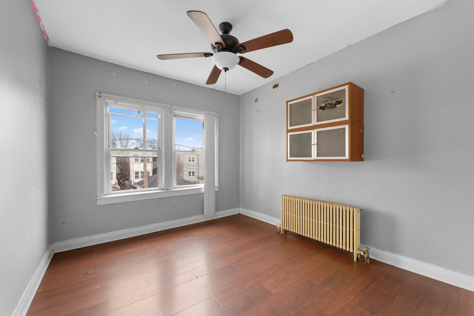 1657 North Austin Avenue Chicago, IL 60639 - Photo 15 of 36 a view of an empty room with a window and wooden floor