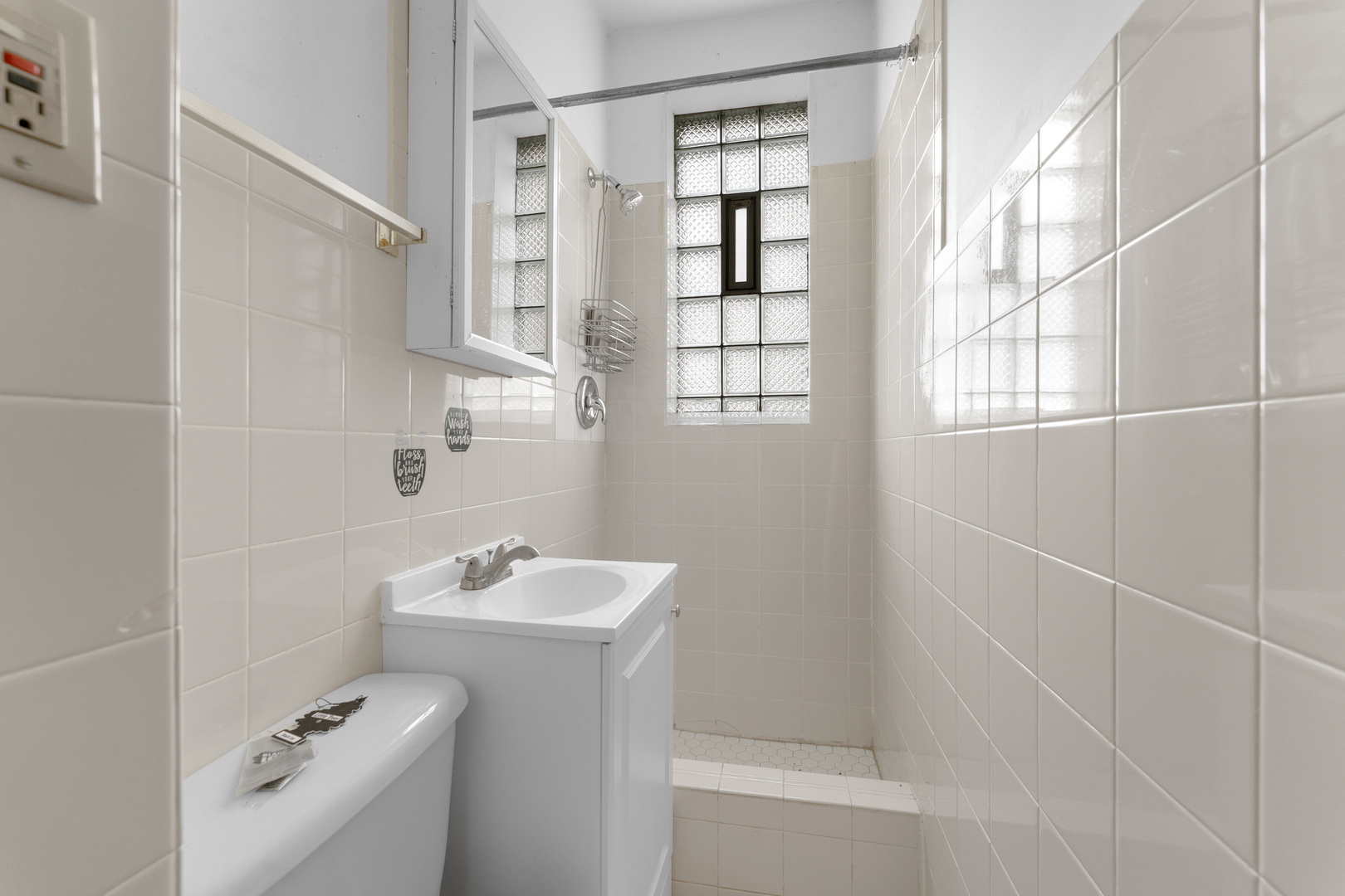 1657 North Austin Avenue Chicago, IL 60639 - Photo 16 of 36 a bathroom with a sink a toilet and shower