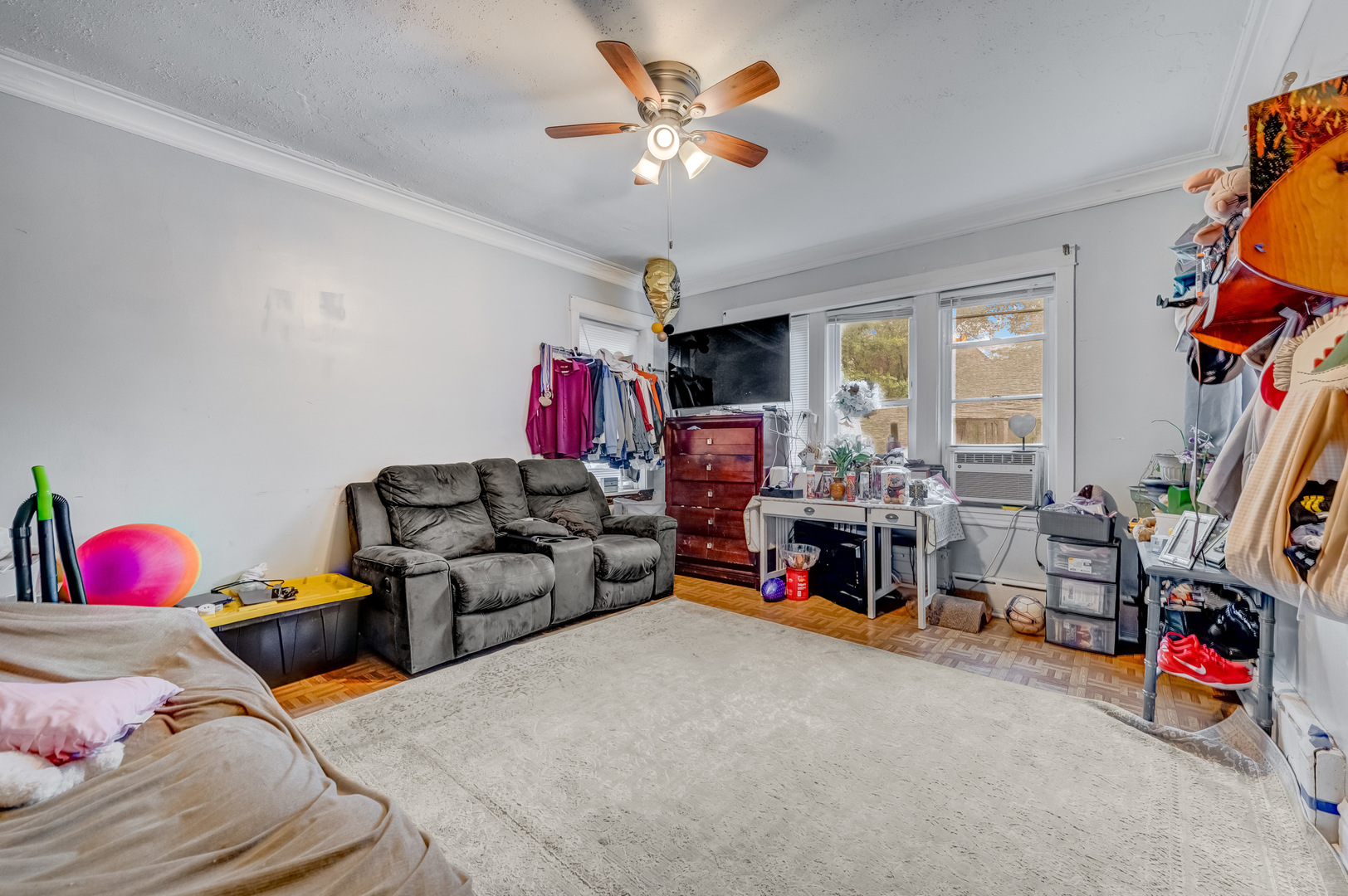 1657 North Austin Avenue Chicago, IL 60639 - Photo 18 of 36 a living room with furniture a flat screen tv and a gym equipment