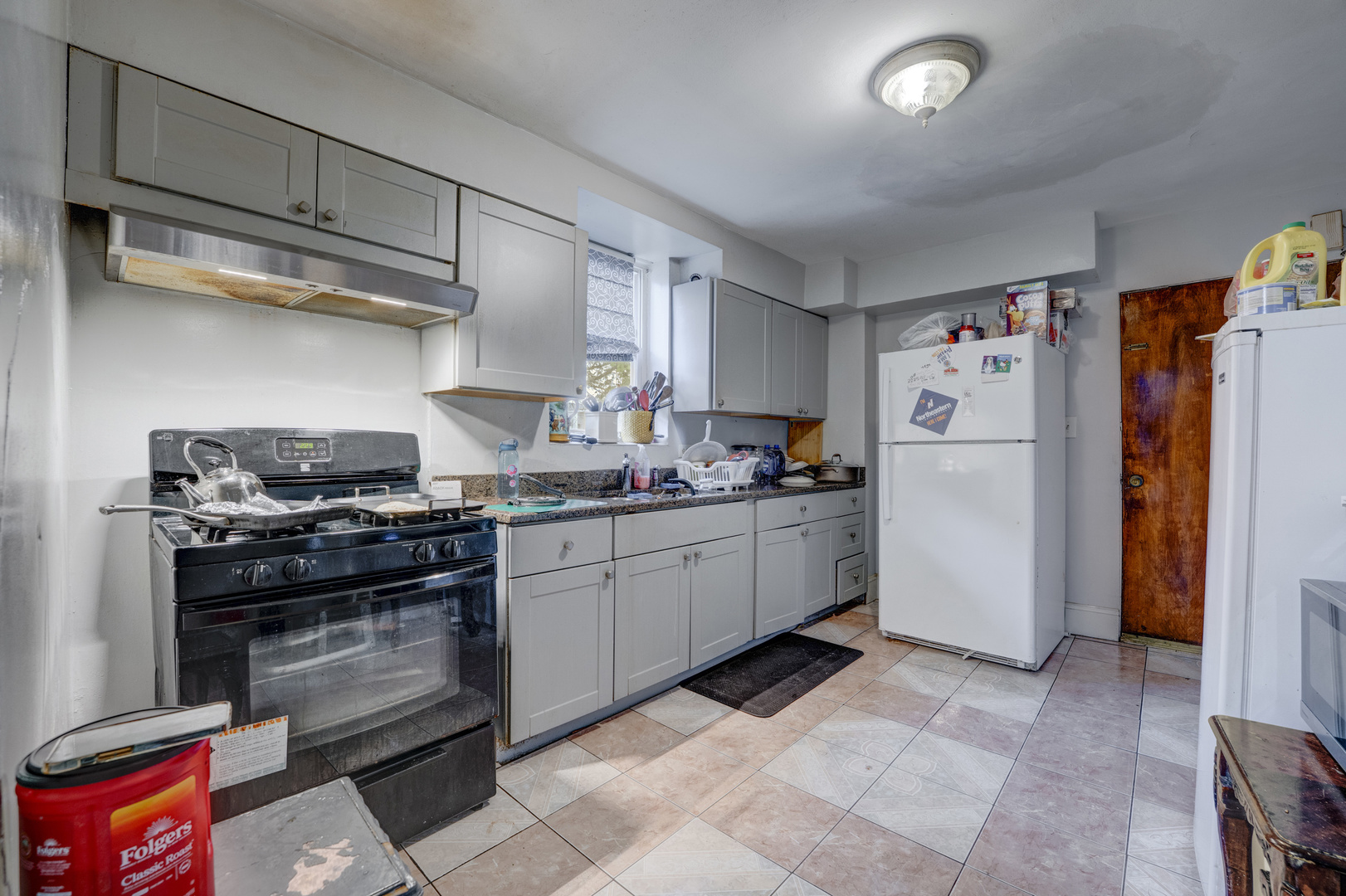 1657 North Austin Avenue Chicago, IL 60639 - Photo 27 of 36 a kitchen with stainless steel appliances granite countertop a refrigerator and a stove top oven
