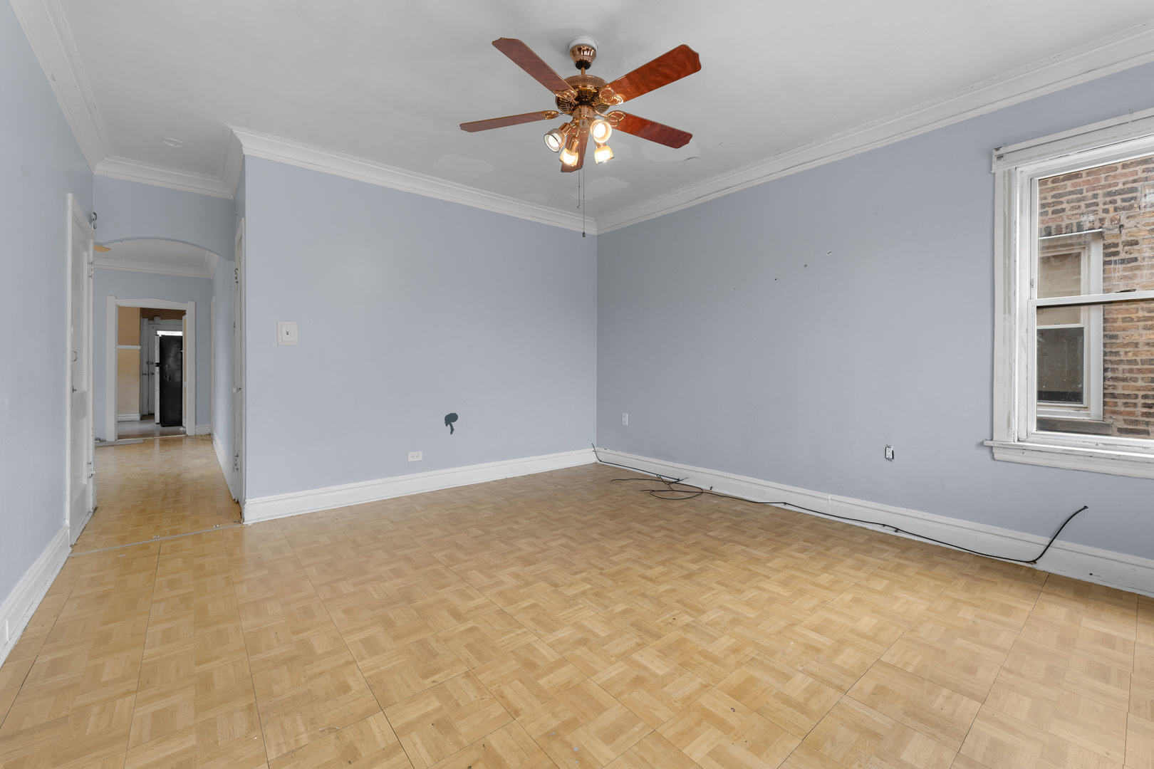 1657 North Austin Avenue Chicago, IL 60639 - Photo 5 of 36 an empty room with windows and fan