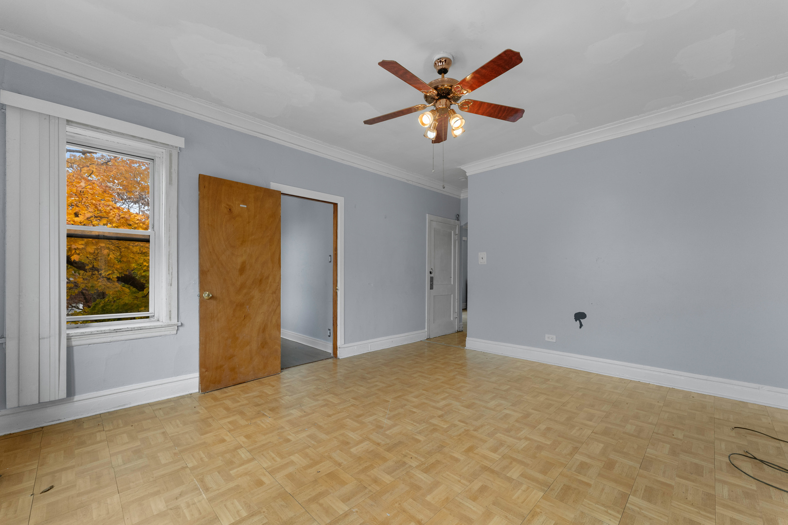 1657 North Austin Avenue Chicago, IL 60639 - Photo 6 of 36 a view of a big room with windows and chandelier fan