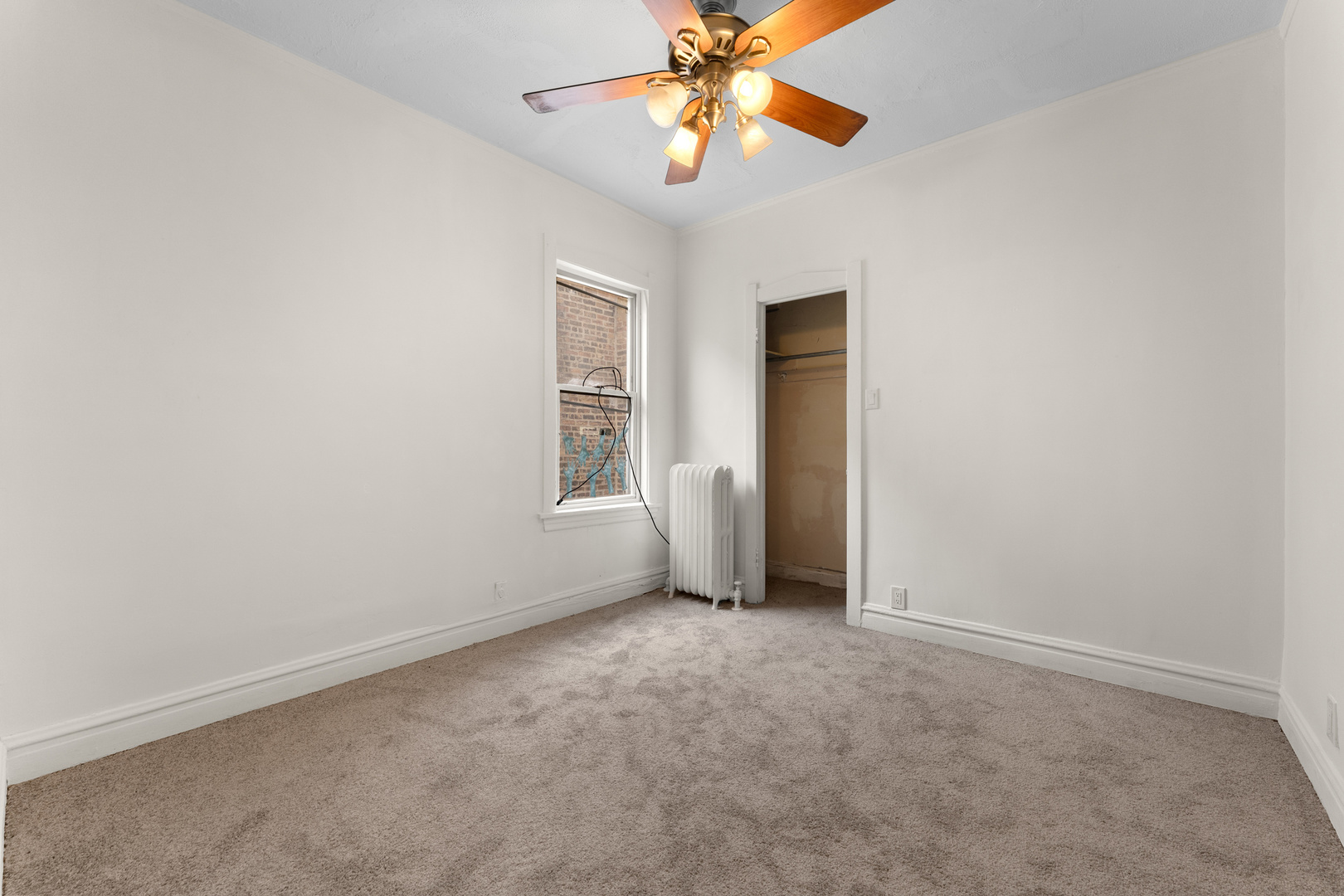 1657 North Austin Avenue Chicago, IL 60639 - Photo 10 of 36 an empty room with windows and fan