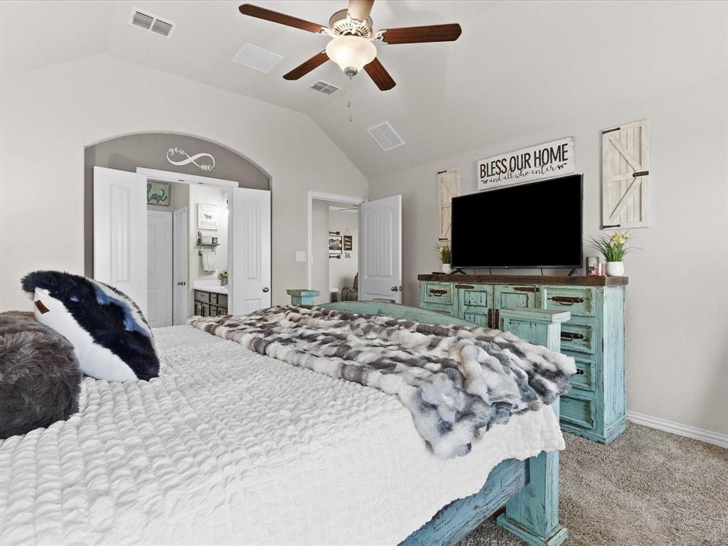 419 George Drive Fate, TX 75189 - Photo 15 of 26 a bedroom with a bed and a flat screen tv