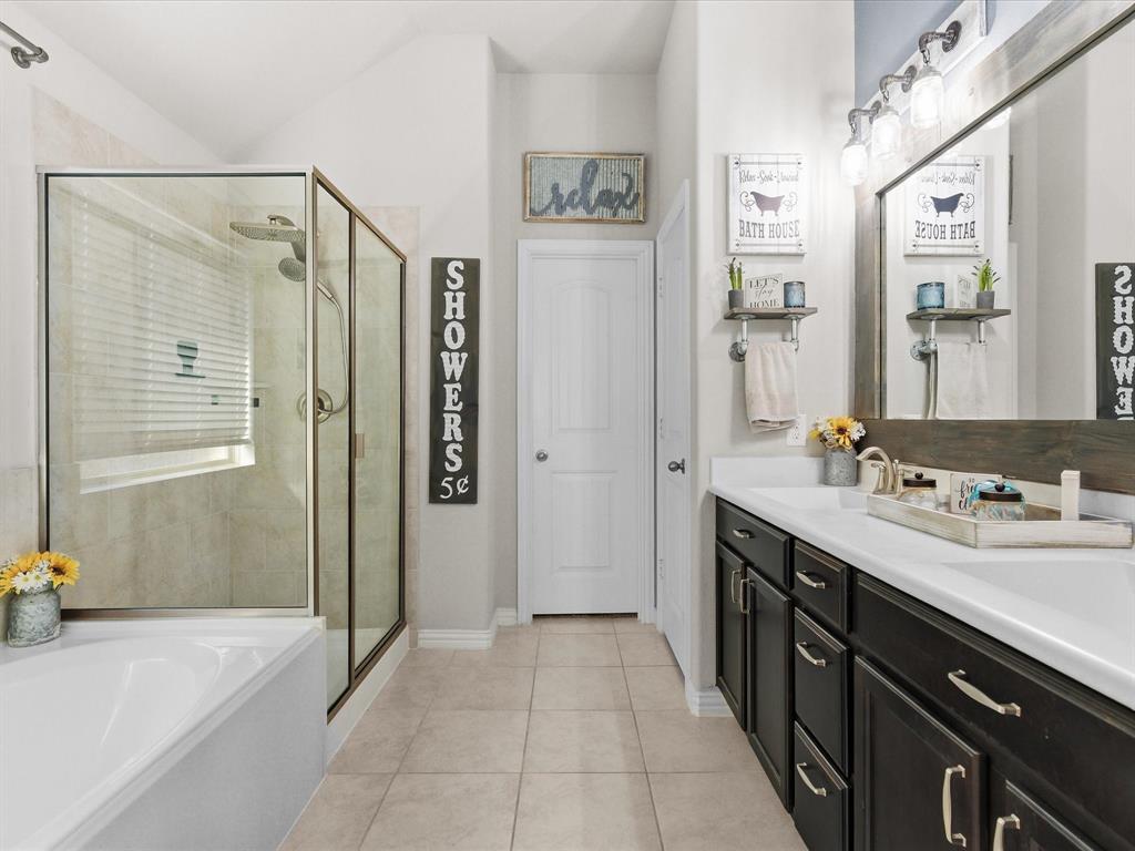 419 George Drive Fate, TX 75189 - Photo 17 of 26 a spacious bathroom with a shower sink and mirror