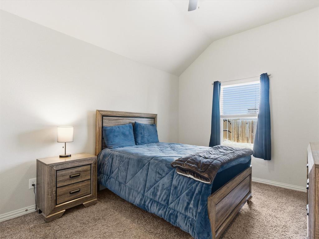 419 George Drive Fate, TX 75189 - Photo 19 of 26 a bedroom with a bed and a dresser