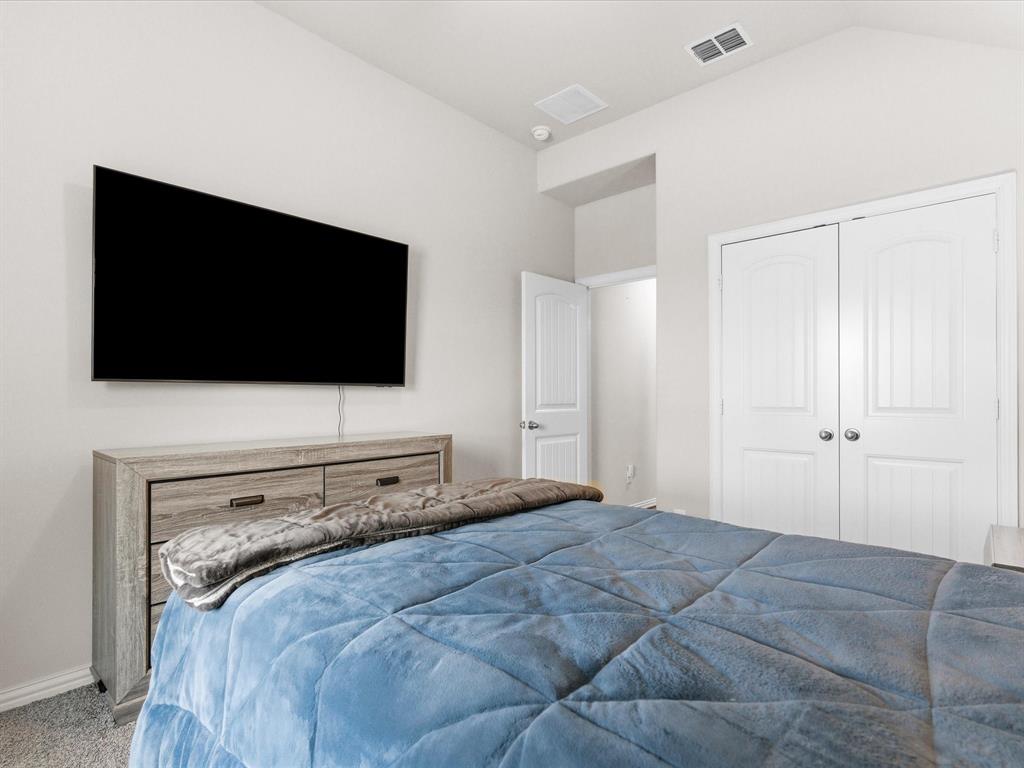 419 George Drive Fate, TX 75189 - Photo 20 of 26 a bedroom with a flat screen tv and a bed